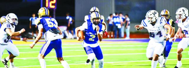 Bucks quarterback Ezra Lujan breaks from the line of scrimmage in an attempt to gain some yardage against Mountain View. Photo by Felipe Fierro