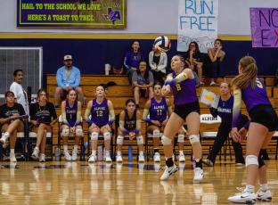 Aila Carpenter bumps the ball back towards the net as Coach Linda Morris and teammate Evelyn Smith look on during Saturday’s matchup against the Wink Lady Cats. Photo by Kara Gerbert