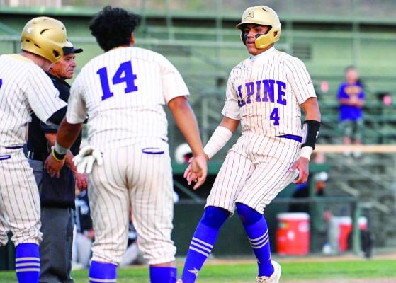 Josh Solis comes into home plate, welcomed by teammate Alec Ramos. Photo by Felipe Fierro