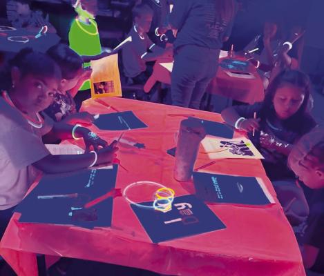 These 2nd graders at Alpine Elementary practiced their math and reading skills under black lights this week during Glow Day. Courtesy photo