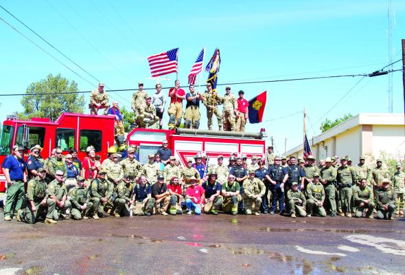 Alpine First Responders, U.S. Border Patrol, and U.S. Army ended the memorial walk from the USBP Alpine Station to the American Legion with a group photo. Photo by Kara Gerbert
