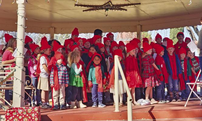 Students from the Alpine Christian School held a caroling program in the gazebo on the lawn at the Brewster County Courthouse last Tuesday. Songs included “Joy to the World” and even the first verse and chorus of “Feliz Navidad.” Photo by Kara Gerbert