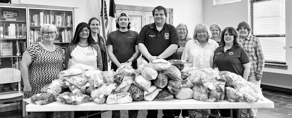 The Women’s Club of Alpine recently donated 50 emergency blankets, 20 fleece blankets, and 85 stuffed toys to the Alpine Volunteer Fire Department. AVFD Fire Chief Andrew Pierce was on hand to accept the donation. Pictured are members of the Women’s Club, Gerri Davis, Amy Struthers, Allison Vidal, Alpine PD dispatcher Will Romero, Fire Chief Andrew Pierce, Candy Whyman, Jan Woodward, JoAnn Seaman, Mayor Catherine Eaves, and Janith Stephenson. Avalanche photo by Kara Gerbert