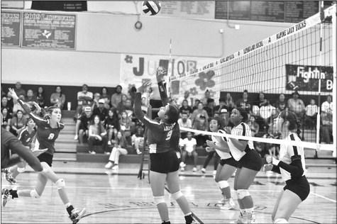 Peyton Kinkade is poised to deliver a kill after Paula Vargas gives an assist at Saturday morning’s game. Courtesy photo