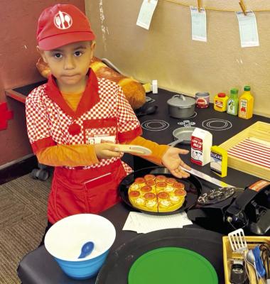 This young bookworm from the Marfa Public Library can now serve you Pizza or any kind of other Bistro favorite in MPL’s new Bookwork Bistro make-believe installation. Photo courtesy of Marfa Public Library