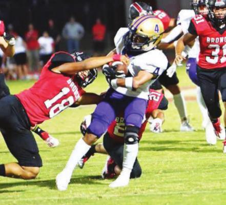 Fightin’ Buck Aiden Garcia clutches the ball on a run against the Broncos in Sonora on Sept. 17 in Sonora. Courtesy photo