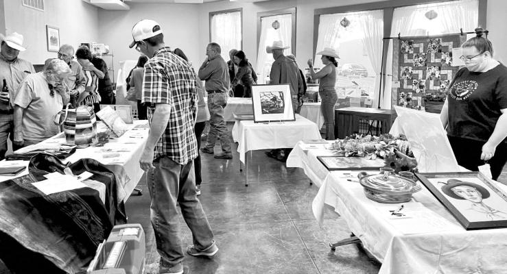Visitors to the Sunshine House annual Wild West Night on Oct. 22 look over a wide range of silent auction items donated by local businesses and individuals. The evening included dinner, live music, and a raffle, with all proceeds benefitting Sunshine House activities in the community. Avalanche photo by Gail Diane Yovanovich