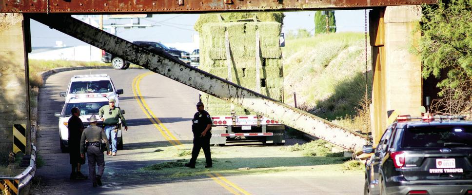 Officers from Alpine Police Department, Texas Department of Public Safety, and U.S. Border Patrol work the scene of the Union Pacific railroad bridge west of Alpine on Highway 90. Around 6 p.m. Saturday, a truck hauling hay to Alpine from Marfa struck and damaged the support beam, one end of which was dislodged from the supporting concrete stanchion. All vehicle traffic was diverted, and the highway closed while crews from Union Pacific were dispatched for repairs. Photo courtesy of Bill Elliott