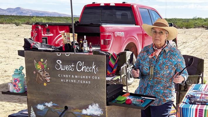 Cindy “Sweet Cheeks” Cox stands with her competition chili cooking set-up on her trail to CASI that begins on October 29. Photo courtesy of Mickey Cox