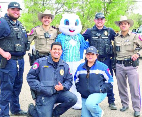 The Easter Bunny kept these officers in line and busy hiding his eggs for all the kids on a chilly Saturday morning at Kokernot Park this past weekend at the annual Easter Egg hunt. Officers in the back row, from L to R, are Officer Campos, Trooper Alvarez, Mr. Bunny, Officer Steiner, and Trooper Caballero. In front are Officer Carrillo and Sgt.Kettani. Photo courtesy of Tona Cat Vega