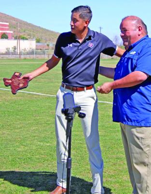 This past Saturday, Sul Ross Lady Lobo Soccer Coach John Dominguez was presented with a plaque honoring the memory of Houston Police Officer Reuben Becerra DeLeon, who was killed in the line of duty on October 26, 2005. Becerra DeLeon was the father of Coach Dominguez. Dominguez was presented with the plaque by Alpine Police Department Captain Felipe Fierro. Photo courtesy of Alpine Police Department