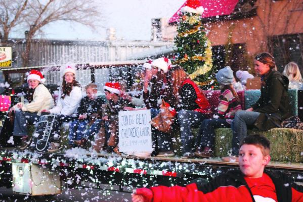 The Big Bend Children’s Choir is always searching for new singers to add to their numbers. Donning Santa hats, and singing joyfully amongst artificial snow flurries, they entertained Alpine locals with carols during the recent Christmas parade. Photo by Joh Covington