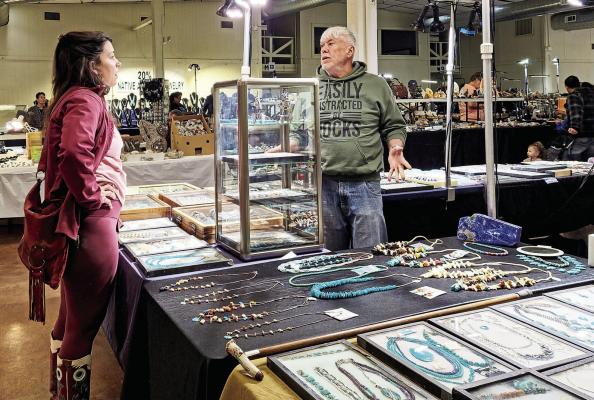 Jeweler Curtis Freeland of Tucson speaks with a customer on Sunday at Alpine’s annual Gem and Mineral Show held at the Alpine Civic Center. Photo by Kara Gerbert