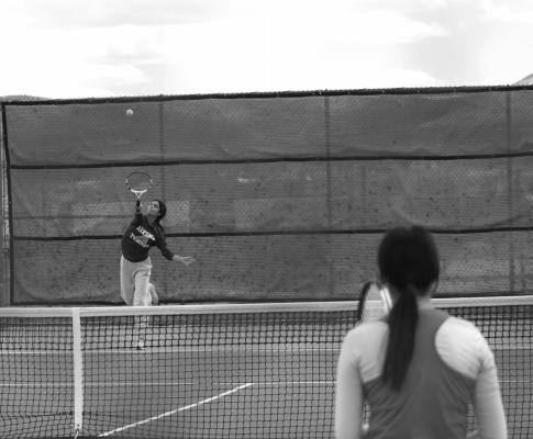 Megan Strothers delivers a serve during doubles play at the Fort Davis Invitational held Tuesday at Sul Ross. Photo by Joh Covington