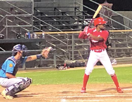 Alpine o6 Cowboy Calvin Graves looks for a pitch against the Santa Fe Fuego. Photo by Ethan Eibe