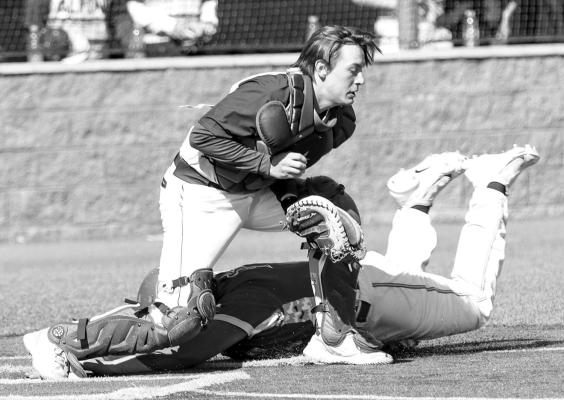 Alpine Fightin’ Buck Teagan Emerson attempts to tag a Regan County player out at home plate during the Comanche Classic tournament held in Fort Stockton. Photo by Shawn Yorks