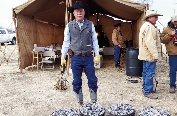 Robert Leese watches over several Dutch ovens full of biscuits he’s cooking at last year’s Chuck Wagon Breakfast held annually in conjunction with the Lone Star Cowboy Poetry Gathering. Photo by Kara Gerbert