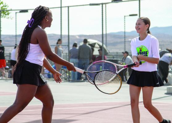 Lady Buck tennis players Shanna Tamale and Jaylynn Celaya are all smiles as they interact at this week’s district tennis tournament. Courtesy photo