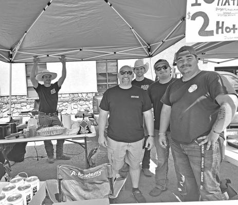 AVFD Fire Chief James Etchison (center) and his trusty side-kicks Isaac Lutz (far left), Colby Nunn, Alex Montemayor, and Jeremiah Pearce are all smiles as they raised funds for the department Saturday afternoon in front of the old Porter’s grocery store on 5th Street with a hot dog and burger cook-out. Photo by Kara Gerbert