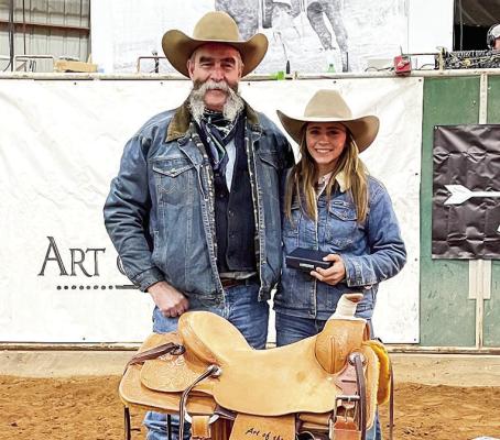 Emilee Charlesworth is shown here with saddle and buckle she recently won at the 2023 Art of the Cowgirl Breakaway Roping in Arizona. Courtesy photo
