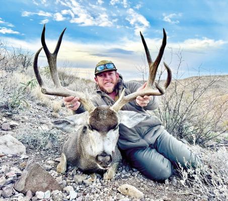 Calan Ahrens, owner of Ahrens Ranch and Wildlife, LLC, is pictured with one of the area’s big mule deer. Courtesy photo