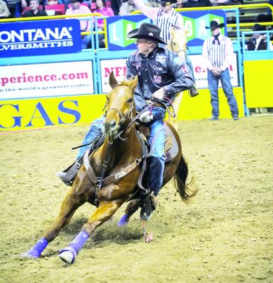 Champion team roper Turtle Powell is pictured here at the Thomas and Mack Center in Las Vegas during the 2013 Wrangler National Finals Rodeo. Photo courtesy of Hubble Rodeo Photos