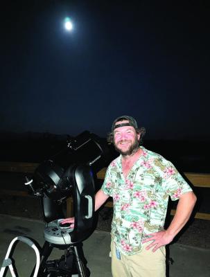 Bryan “Devo” Devonshire poses with one of his telescopes during one of his star tours. Photo courtesy of Astro Mucho