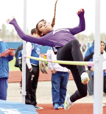 Danica Mulholland clears the bar during the high jump event. Mulholland placed third recently at the Pecos Relays. Photo by Shawn Yorks