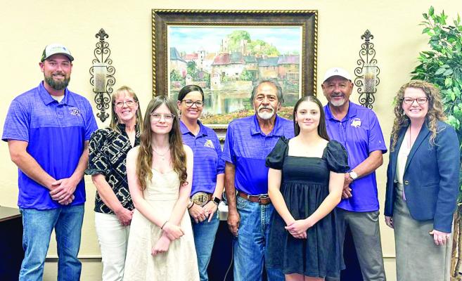 Alpine seniors Teresa Ritzi and Trinity Vega pose with the Alpine ISD Board of Trustees after being presented with the 2026 AISD Board of Trustees scholarships. From left are Josh Cross, Niki Ahrens, Teresa Ritzi, Haley Babb, Eddie Natera, Trinity Vega, Joe Portillo, and Dr. Michelle Rinehart. Photo by Kara Gerbert