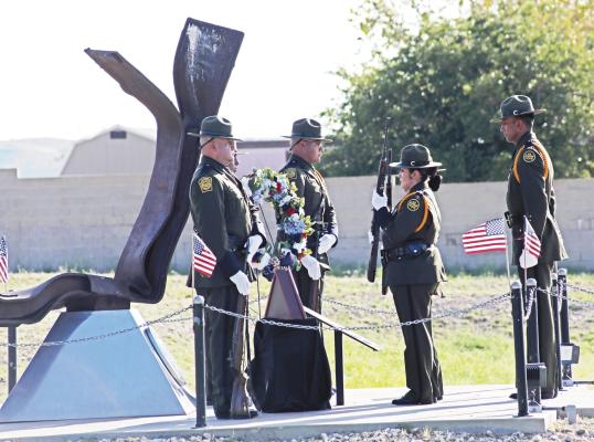 Agents with the U.S. Border Patrol in Alpine stand at attention during the 9/11 memorial ceremony held last Friday at the Alpine station. The station has marked this day each year in front of this piece of the Twin Towers that has been placed on the grounds as a memorial to the almost 3,000 lives lost on that fateful morning. Courtesy Photo