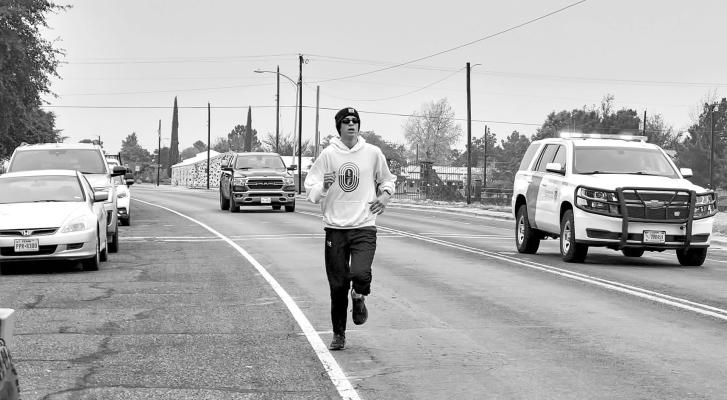 Martin Sablatura, a senior cross-country athlete at Alpine High School took first place in Saturday’s David Delaney 5K held in honor of the fallen U.S. Border Patrol officer. Sablatura had a time of 21:06 and all proceeds of the race go to benefit the Delaney family. Photo by Kara Gerbert
