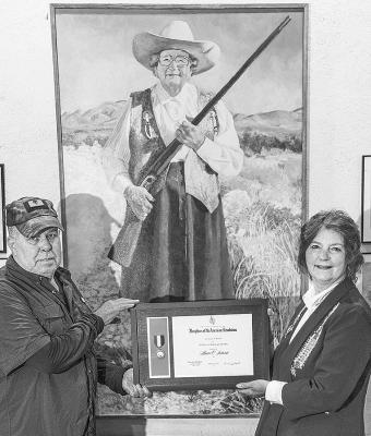 Carol Dunn, Chaplain and Chair of American History for the Lansing, MI chapter of the National Society Daughters of the American Revolution presents the first Women in American History Award honoring the late Hallie Crawford Stillwell to John W. Miller. Courtesy photo