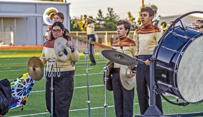 Zaelynn Ruiz, Jonathan LeBlanc, and Matthew Pitts, part of the percussion section for the Fightin’ Buck Band played their part in their final performance before their UIL marching contest in Odessa. Photo by Kara Gerbert