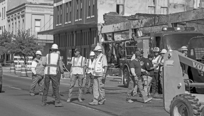 Members of area government agencies, as well as local contractors, conferred last Thursday during the collaborative effort to complete the extinguishing of any leftover hot spots in the tragic fire that wiped out local businesses in downtown Alpine recently.