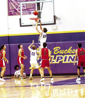 Kelton Tarrant tips the ball back into the net after a layup from Dae Hardwick left him on the floor as he moved through the pack of Coyotes from Tornillo. Photo by Kara Gerbert
