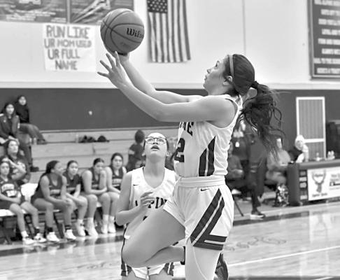 Novah Carrasco attempts a layup during a home game this month. Photo by Felipe Fierro