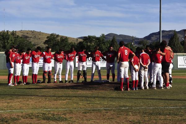 The entire Alpine Cowboys team circles the pitcher’s mound during a pregame ceremony honoring the life of Cowboys pitcher Jared Strait at Kokernot Field Monday, June 12, 2023. Strait’s No. 57 jersey was placed over the pitching rubber.