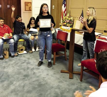 Melissa Orozco and Joyce Baumann receive certificates and prizes for the winning essay and for being the outstanding Texas history teacher. Photo courtesy of DRT