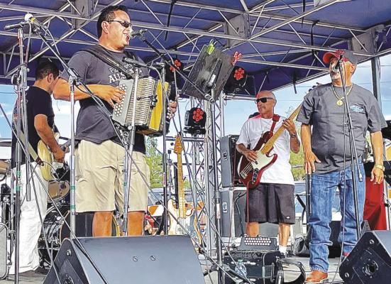 Local band Puro Party All Starz performed Saturday afternoon at Fiesta 1888 for a massive crowd on Murphy Street in Alpine. Photo by Beth Peabody