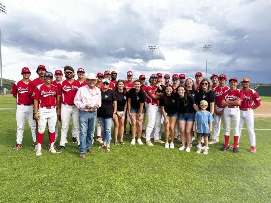 The Alpine Cowboys pose for a group photo with representatives from Ellyson Abstract, the official game night sponsor, on July 25. The Cowboys celebrated the evening with a 10-7 victory over the Roswell Invaders at Kokernot Field. Courtesy photo