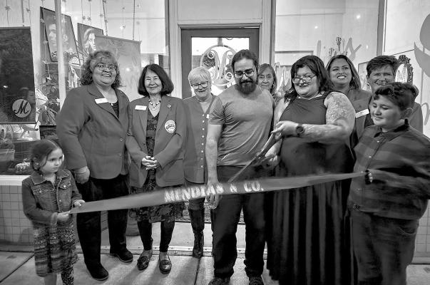 Clara Mendias, owner of Mendias and Co. held a ribbon cutting on Saturday evening in honor of her 10 years of doing business in Alpine. Pictured are Cora Ybarra, Elliott Ybarra, Mendias, and Domingo Mendias along with members of the Alpine Ambassadors. Photo by Kara Gerbert