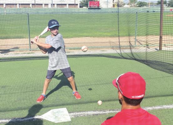 Cowboys outfielder Andrew Capone throws a soft toss to Thomas Freeman of Pensacola, Fla., in the batting cages at Kokernot Field in Alpine. Photo by Ethan Eibe