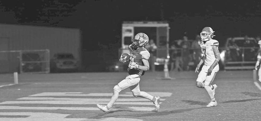 Fightin’ Buck running back Logan Smith carries the pigskin into the endzone in one of six touchdowns he made on behalf of the Bucks in their win over Odessa Compass last Friday Photo by Felipe Fierro