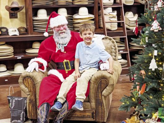 Quinton Briggs held nothing back as he told Santa about wanting a boat with a trailer to go along with it. He also told Santa he was going to be out of town for Christmas, and Santa assured him that wouldn’t be a problem. Photo by Kara Gerbert