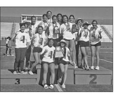 The Alpine Lady Buck track and field team ran away with the Area championship for the fourth year in a row. Pictured are the girls and their Coach, Cory Cason. Courtesy photo