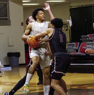 Sul Ross’ Camren Roper battles through a pair from Oklahoma Christian last Thursday night as he attempts to add points to the board for the Lobos. Photo by Kara Gerbert