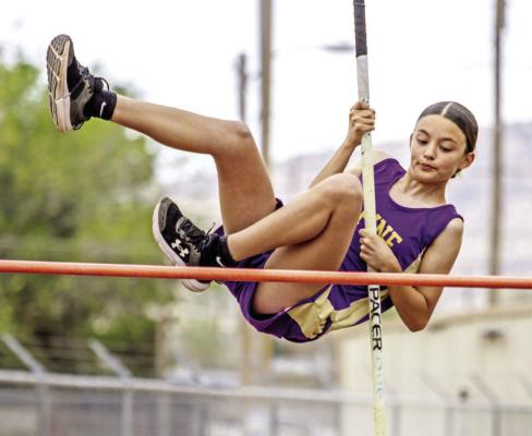 Alpine Middle Schooler Maxine Pitts explodes over the crossbar during the girl’s pole vault at last Wednesday’s district track meet at Buck Stadium. Pitts competed against competitors from Presidio, Kermit, and her fellow Lady Bucks. Photo by Kara Gerbert