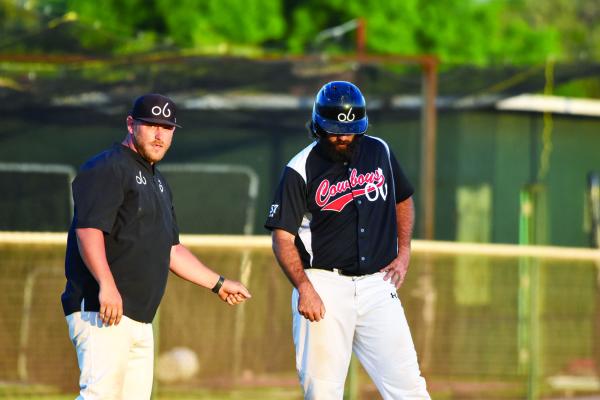 Alpine Cowboys Skipper Lance Meyers gives a little instruction to slugger James Prockish as he holds at 3rd base looking to move across home plate during the Cowboys’ win over Roswell on Saturday. Photo by Julie Myers