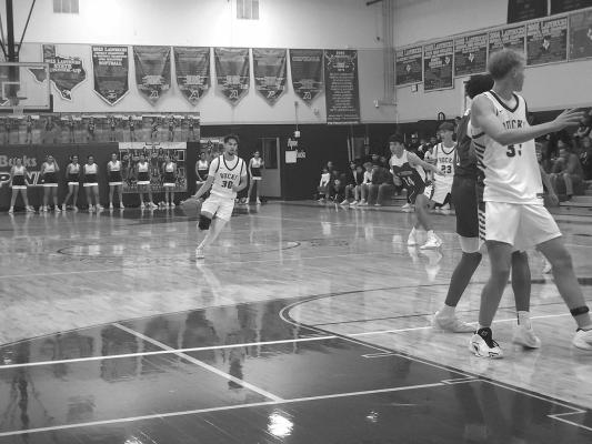 Senior Ferris Daley pushes the ball up the court, setting the pace for the Alpine Bucks’ offense. Photo by Kara Gerbert