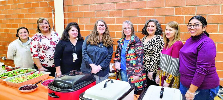 Marathon ISD faculty and staff Jasmine Garcia, Monica Pinedo, Vicky Sanchez, Melissa Barlow, Chris Jonson, Pauline Hernandez, Chelo Salmon, and McKayla Aguilar pause for a photo at the Marathon ISD community Thanksgiving dinner held at the school cafeteria. Avalanche photo by Roxanne Hill